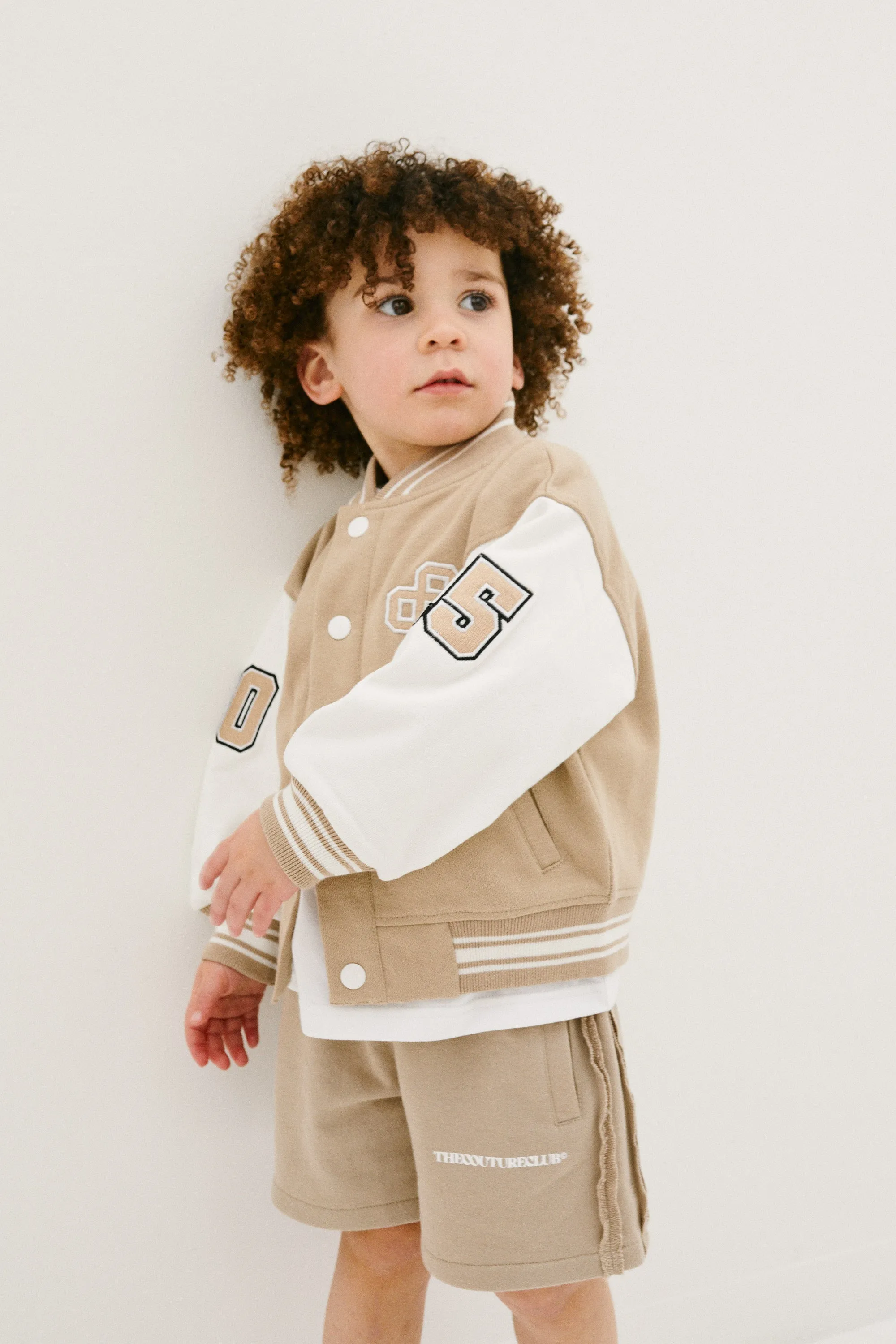 KIDS EMBLEM VARSITY BOMBER JACKET - BEIGE